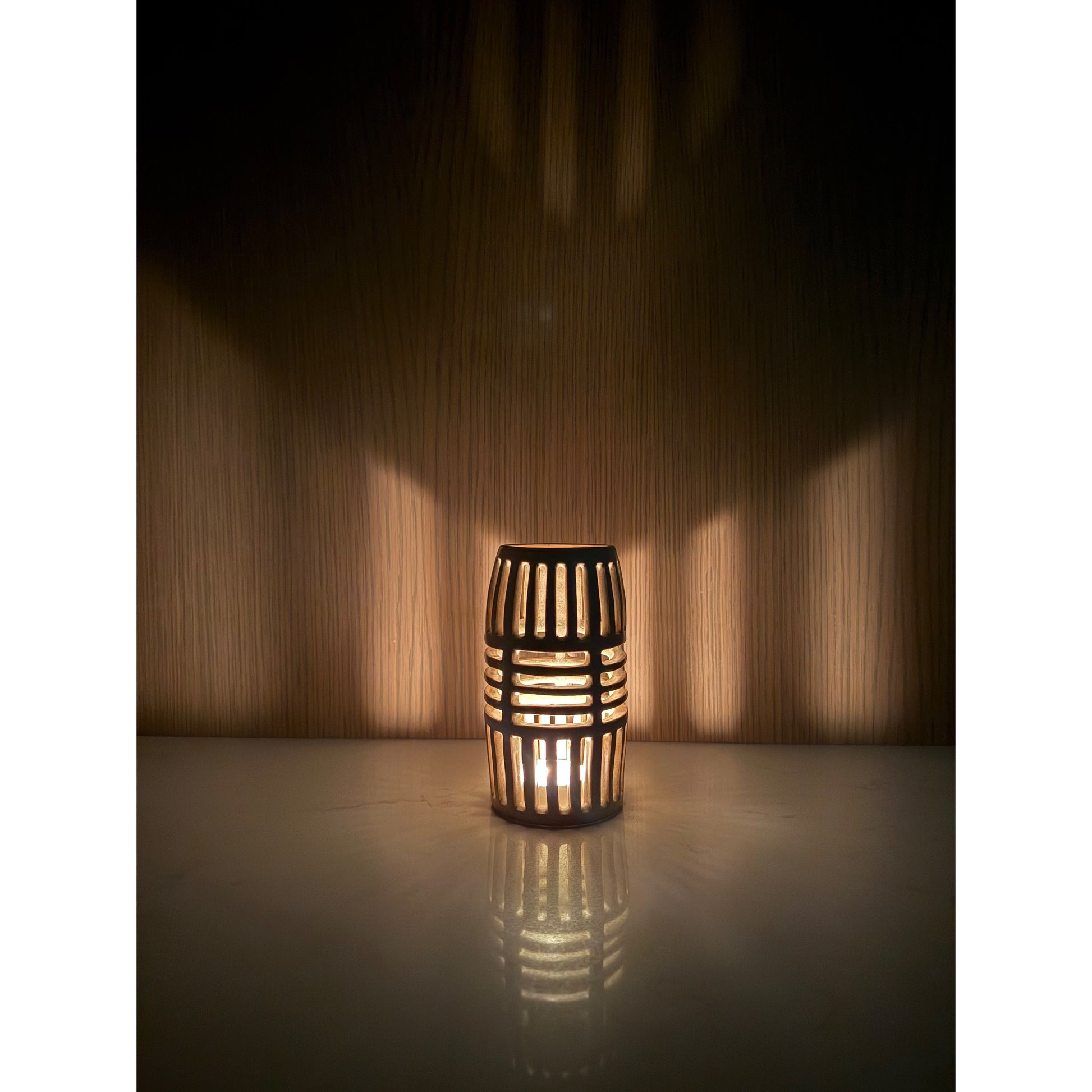 Decorative lantern casting shadows on a wood wall